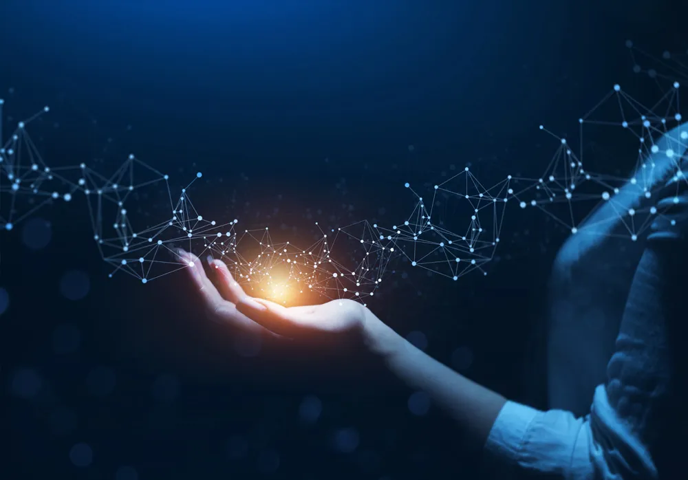 Open hand holding a glowing network of light